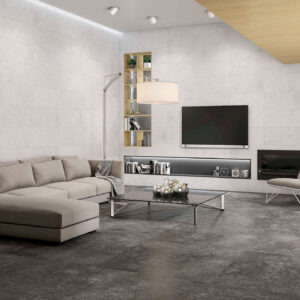 ADVANCE-Salón_100x100_HD Sala de exposición con pavimento cerámico gris oscuro y revestimiento mural claro