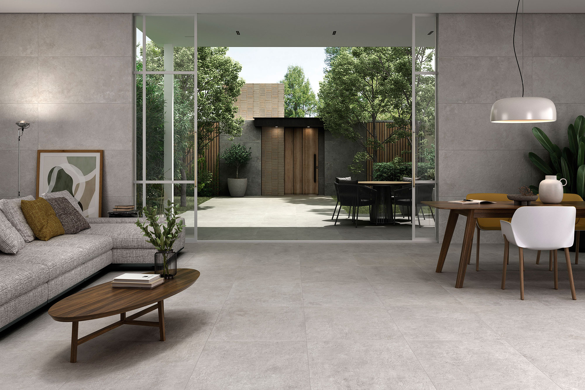 Showroom de azulejos con salón moderno, suelo y paredes de gres gris y ventanal al jardín