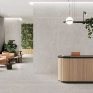 Mostrador de madera, butacas y muro vegetal sobre pavimento y revestimiento cerámico gris