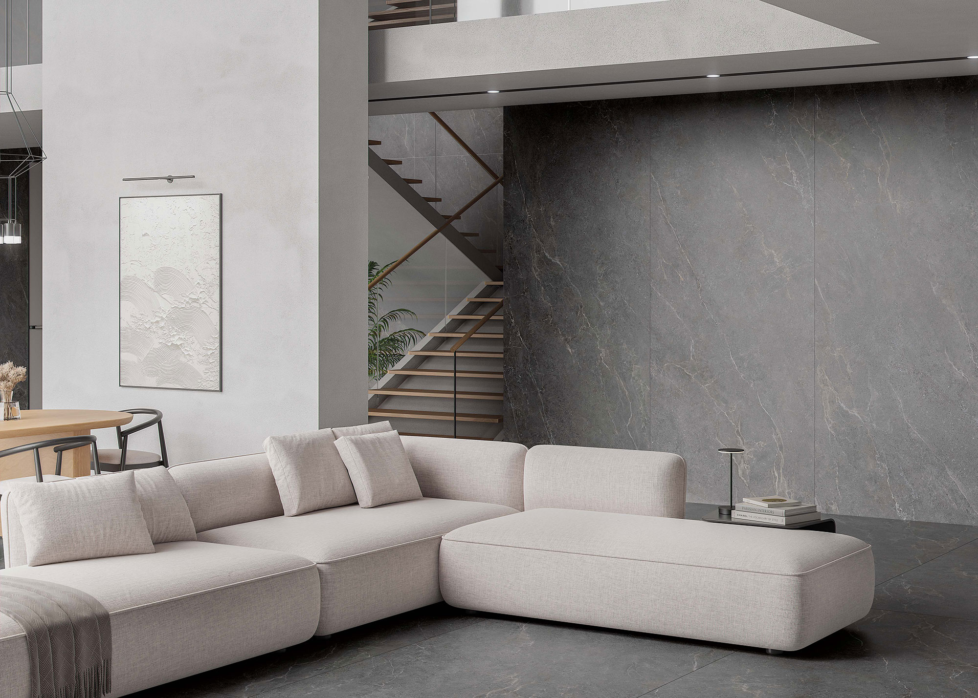 Salón showroom con sofá modular beige sobre pavimento y revestimiento cerámico gris