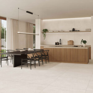 Cocina abierta con suelo y revestimiento cerámico claro, isla de madera y mesa negra