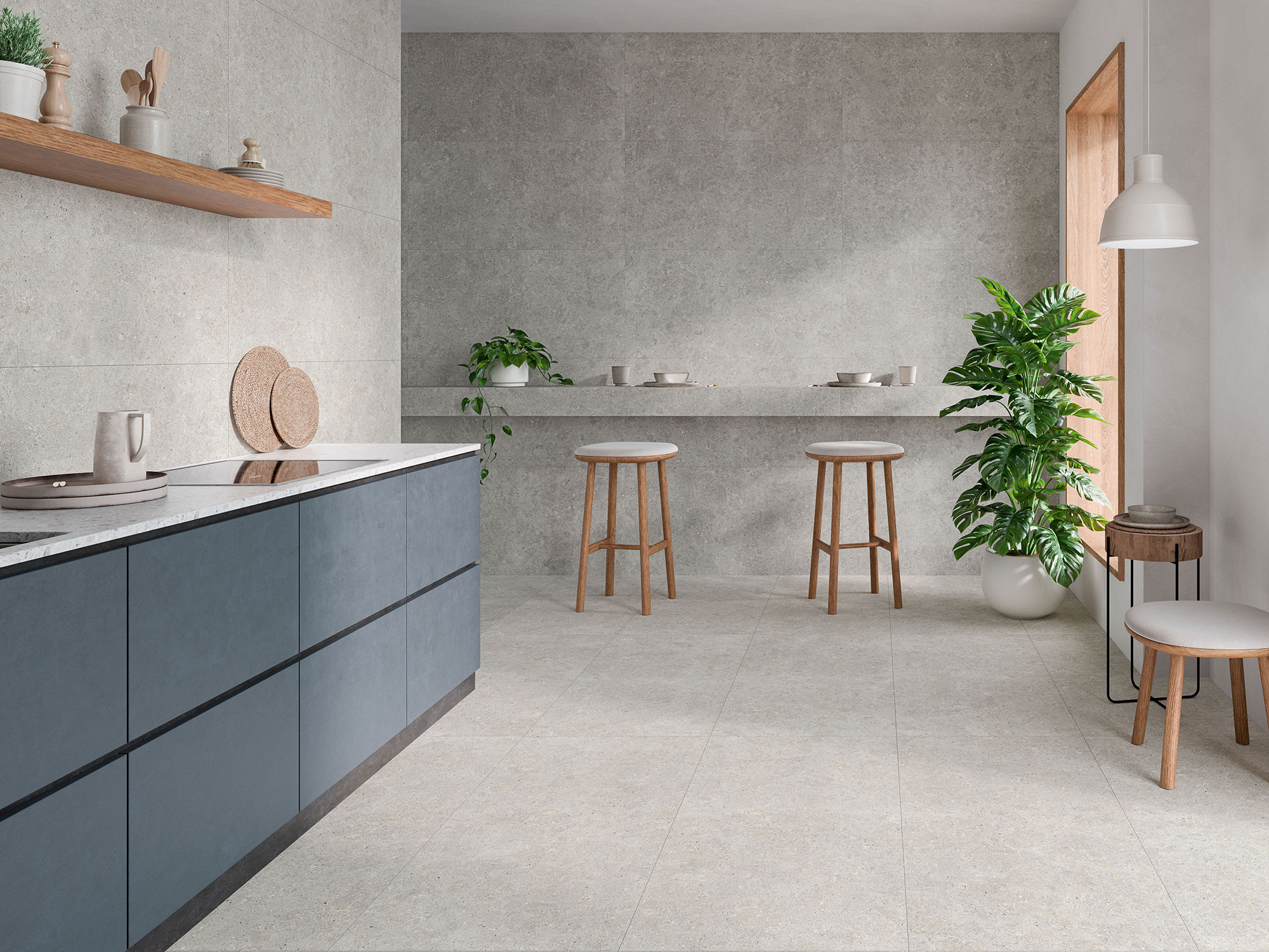 Showroom de azulejos: cocina con pavimento y revestimiento cerámico gris, muebles azules y plantas.