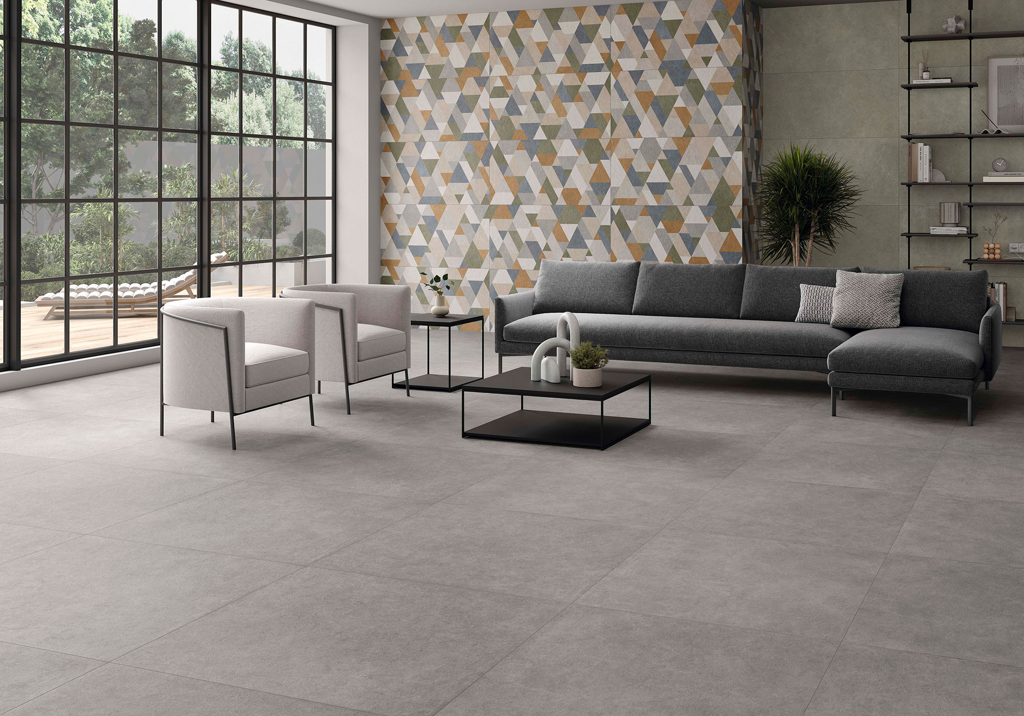 Showroom con suelo losas grises y pared revestida azulejos geométricos multicolor.