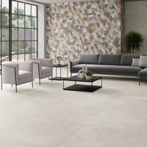 Sala moderna con pavimento cerámico claro y pared de azulejos geométricos multicolor