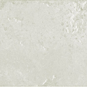 Azulejo cerámico rectangular beige claro, textura moteada y bordes desgastados