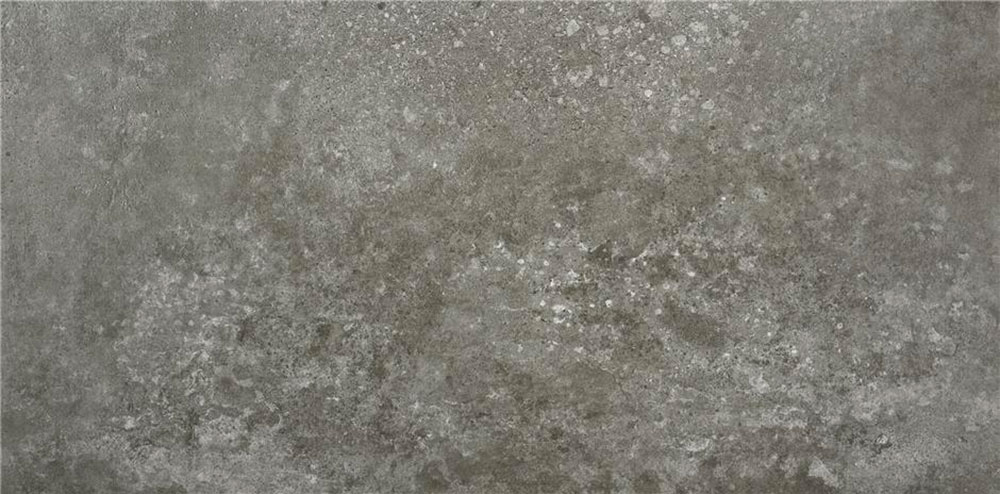 Azulejo cerámico gris efecto hormigón con textura envejecida y motas blancas