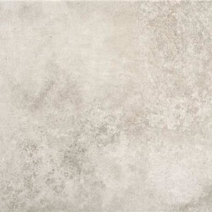 Baldosa cerámica efecto hormigón gris claro con textura moteada