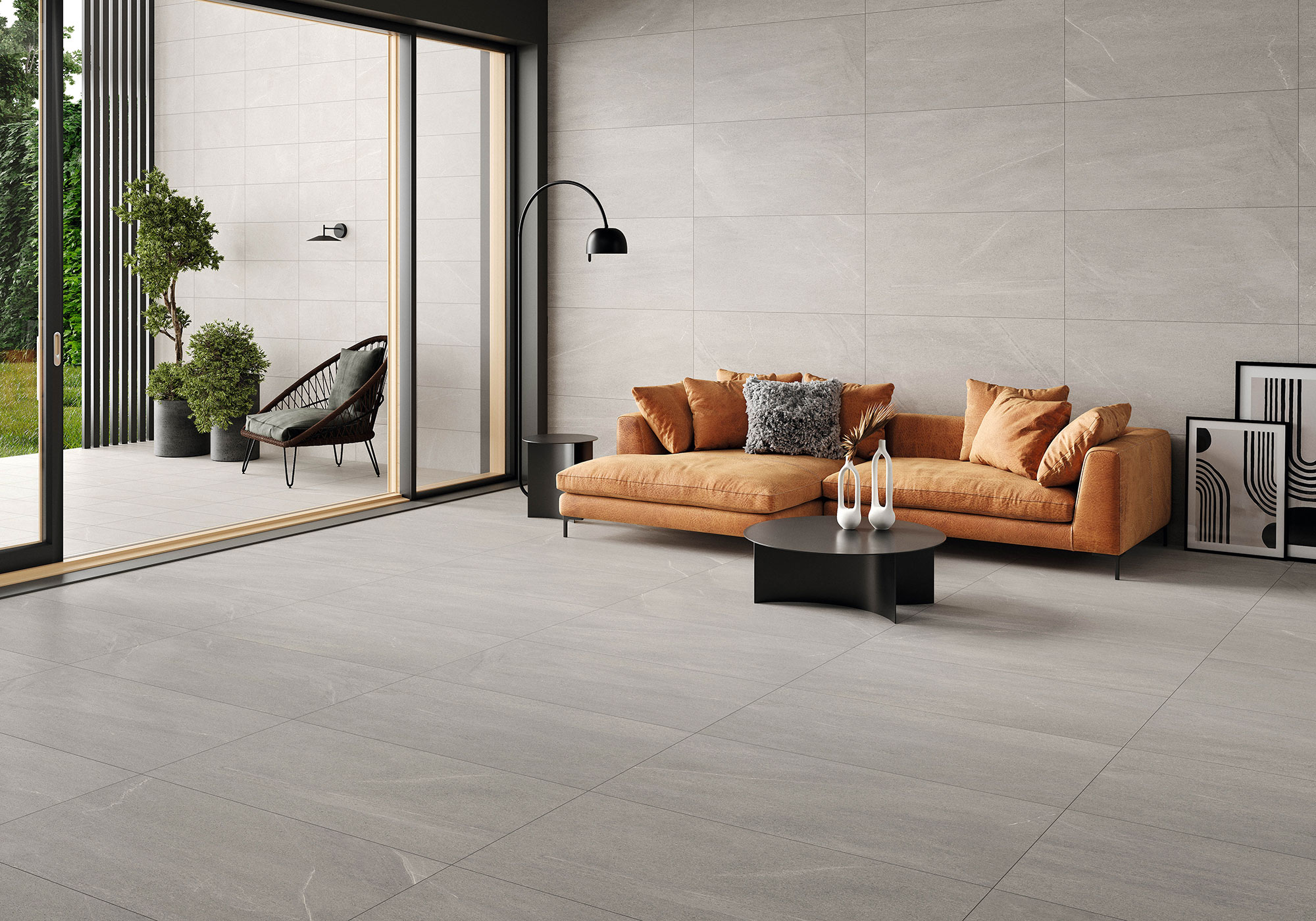 BELLEVUE-GREY-60X120_30X60 Showroom con pavimento y revestimiento cerámico gris, sofá mostaza y terraza.