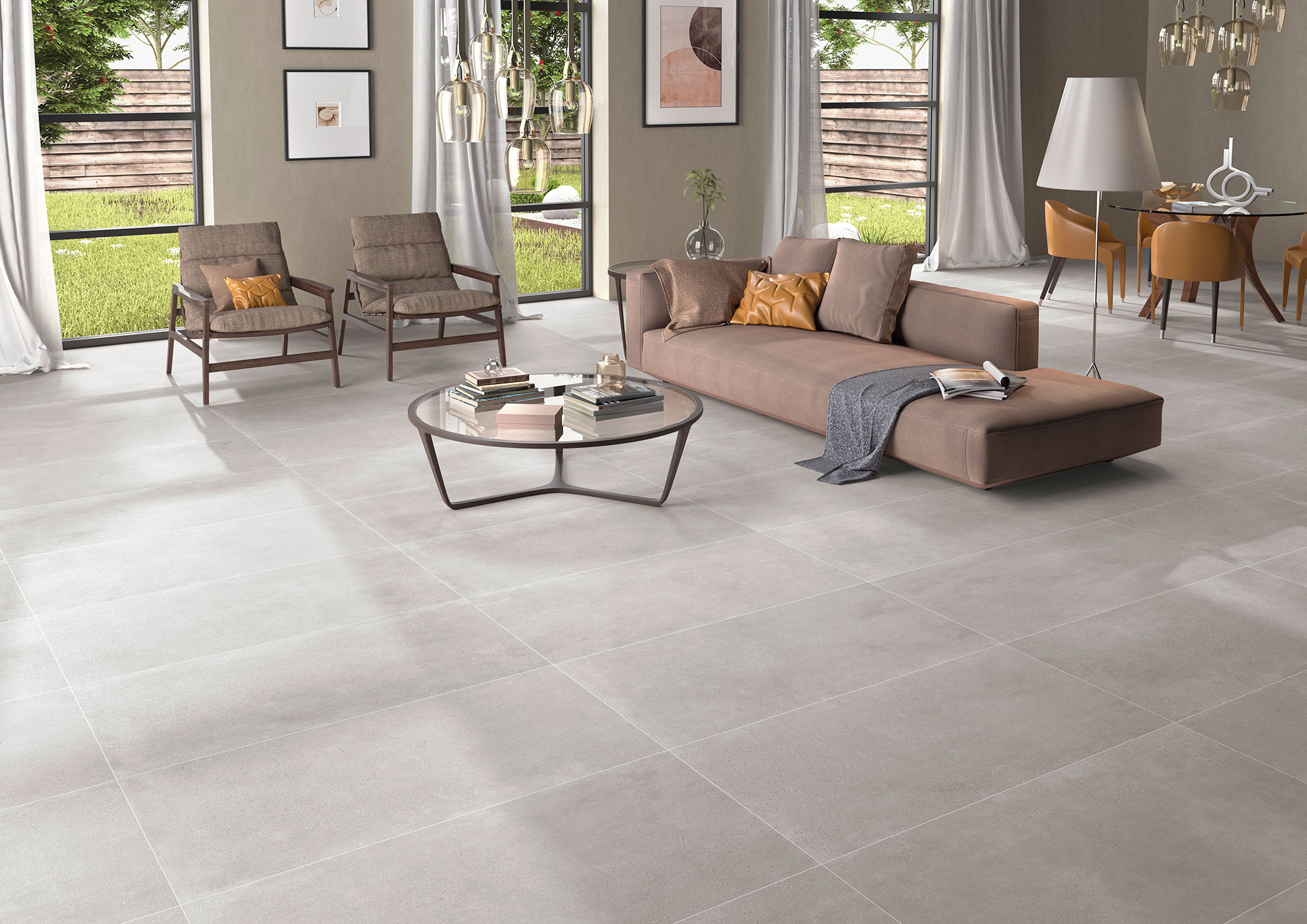 Salón luminoso con pavimento cerámico gris mate, sofá bajo, mesa de centro circular y ventanales.