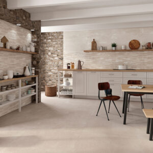 Exposición de azulejos: cocina rústica con pavimento y revestimiento cerámico crema y muro de piedra