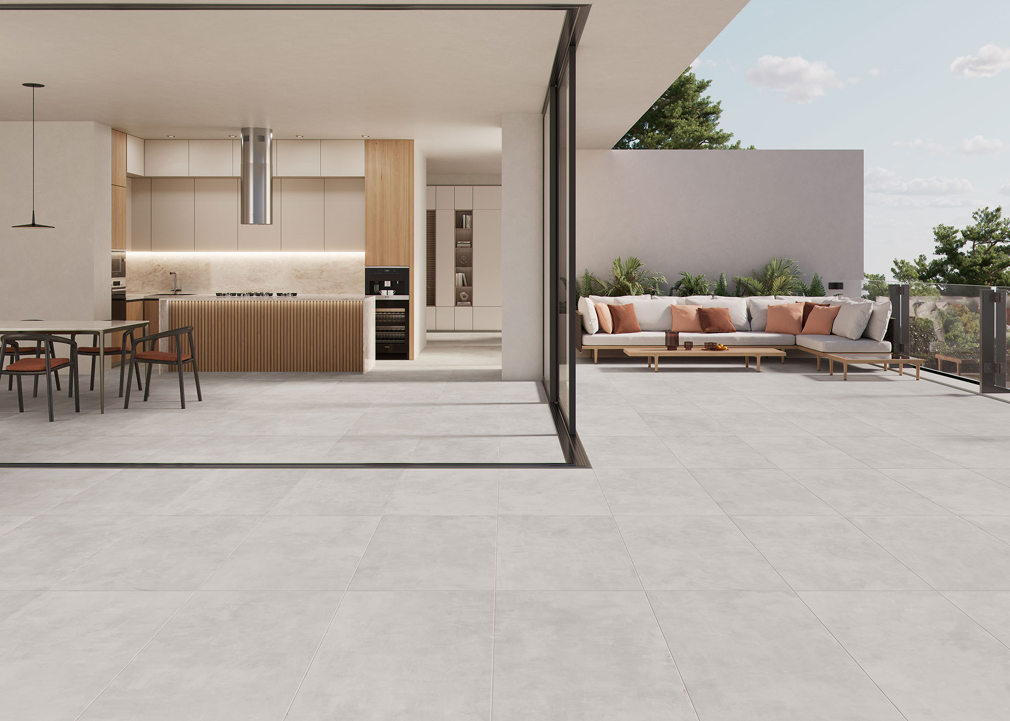 COLUMBIA-GREIGE-60x120-RGB-AMB-01 Espacio cocina-terraza con pavimento de losas cerámicas gris claro, isla de madera y sofá