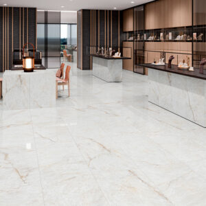 Tienda de azulejos con suelo y mostradores de porcelánico blanco veteado