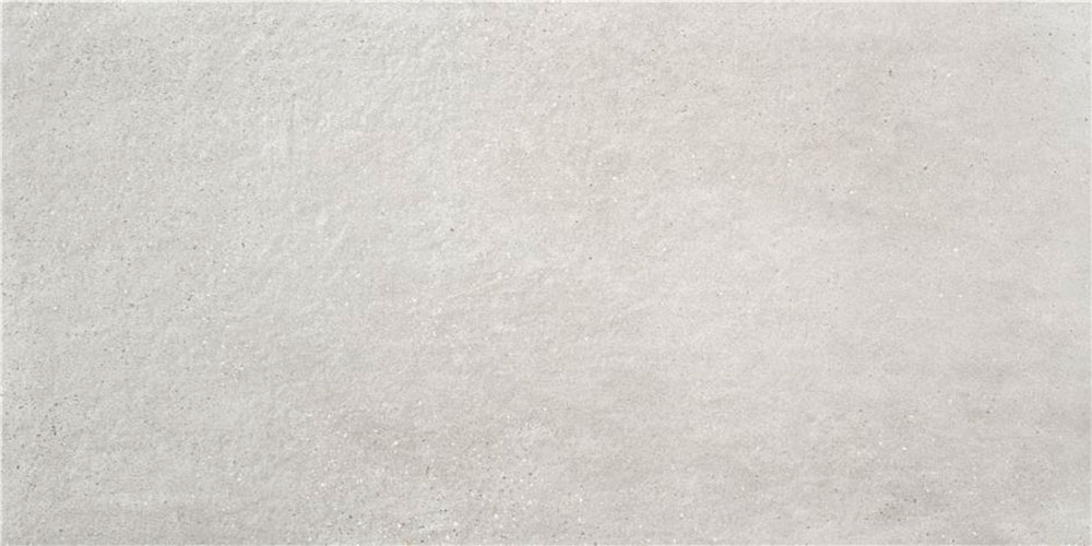 Baldosa cerámica efecto hormigón gris claro mate con textura sutil y microgranos