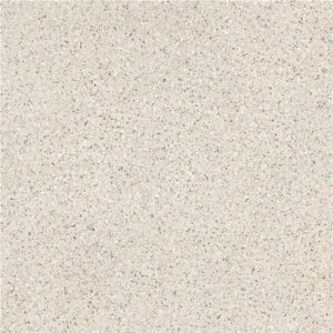 Azulejo porcelánico beige claro tipo terrazo con pequeñas motas grises y crema