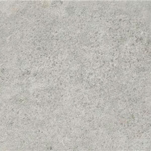 Baldosa cerámica gris efecto hormigón mate con textura sutil