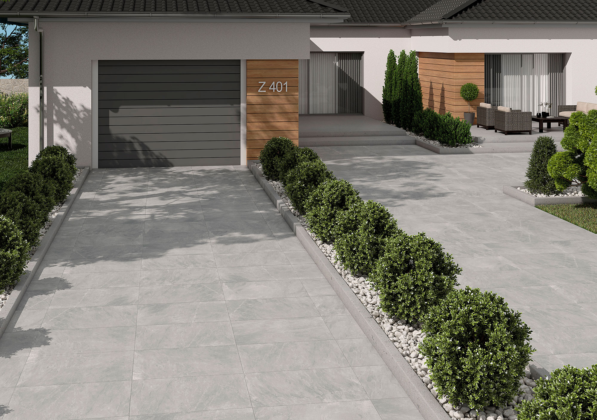 Porche y entrada con pavimento cerámico gris efecto piedra, setos y garaje