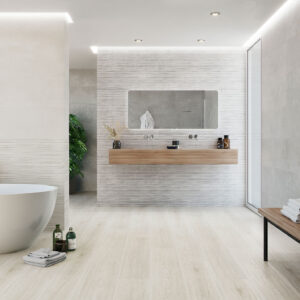 Baño de exhibición con azulejos y pavimento cerámico claros, bañera y lavabo flotante