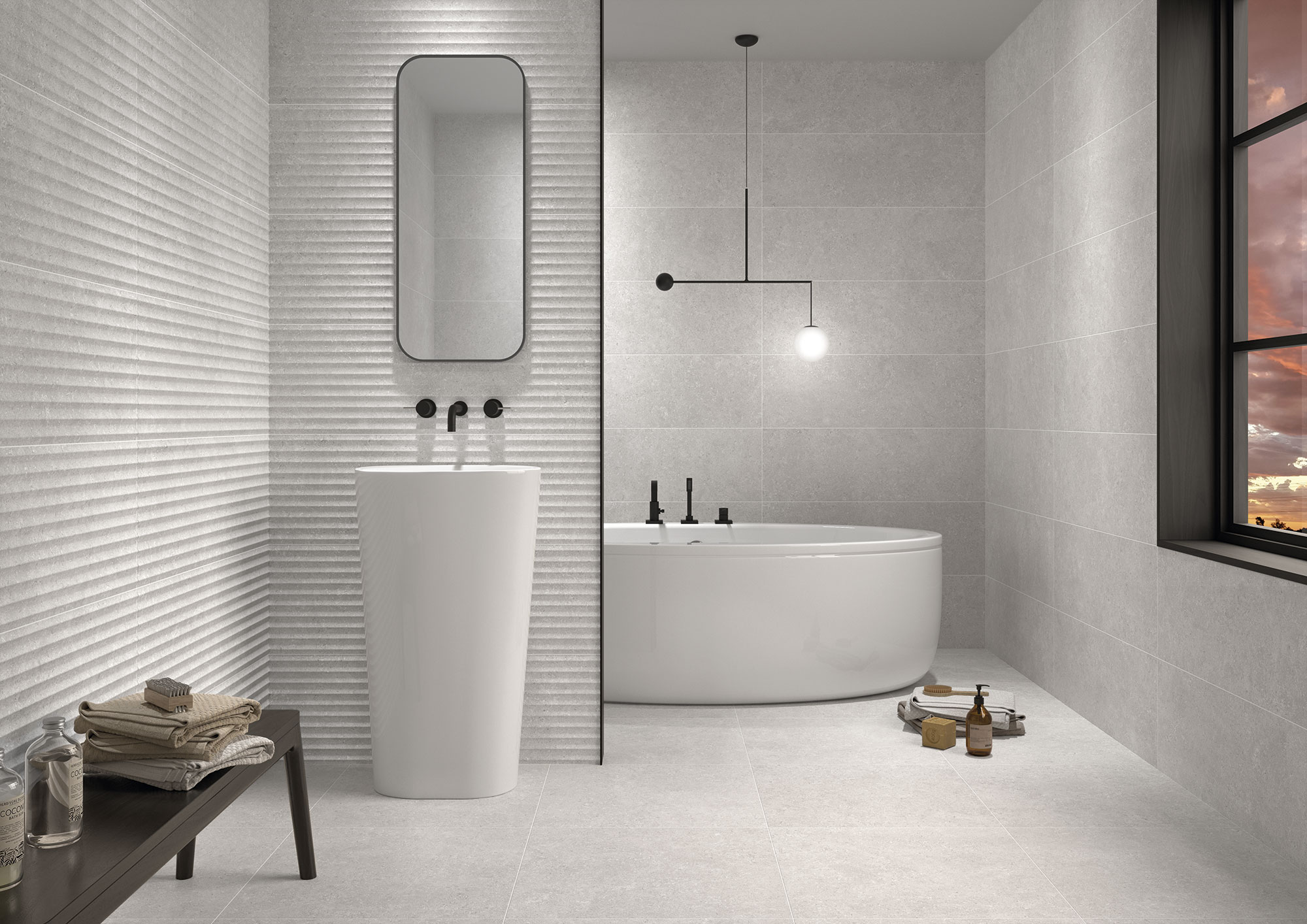 Baño minimalista con azulejos cerámicos claros, revestimiento texturizado, lavabo y bañera