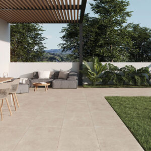 Terraza moderna con pavimento cerámico beige, comedor exterior y sofá junto a jardín