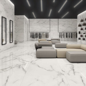 Showroom de pavimentos y revestimientos en porcelánico blanco efecto mármol con asientos.