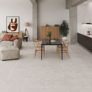 Salón-cocina abierto con pavimento cerámico gris claro, sofá beige y mesa de comedor negra