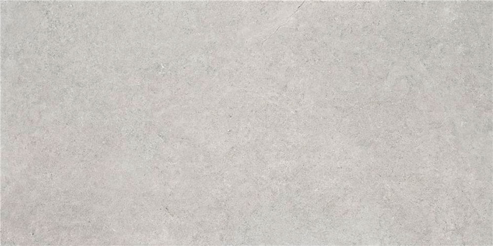 Baldosa cerámica efecto hormigón gris claro con textura uniforme