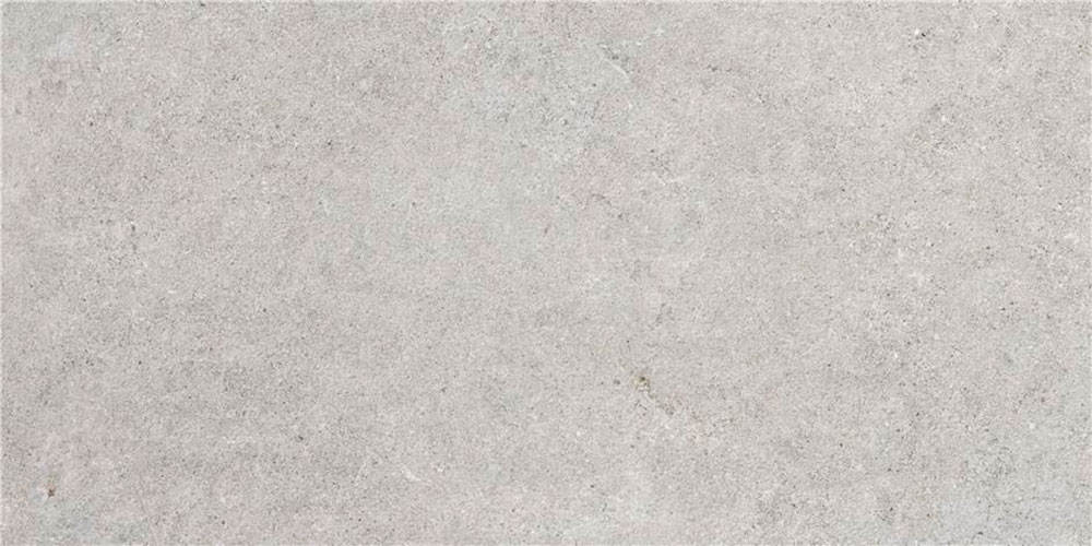 Baldosa cerámica gris claro con textura tipo hormigón