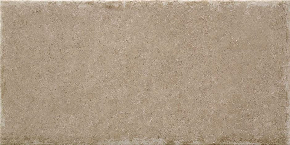 Azulejo cerámico rectangular beige con textura pétrea y bordes desgastados