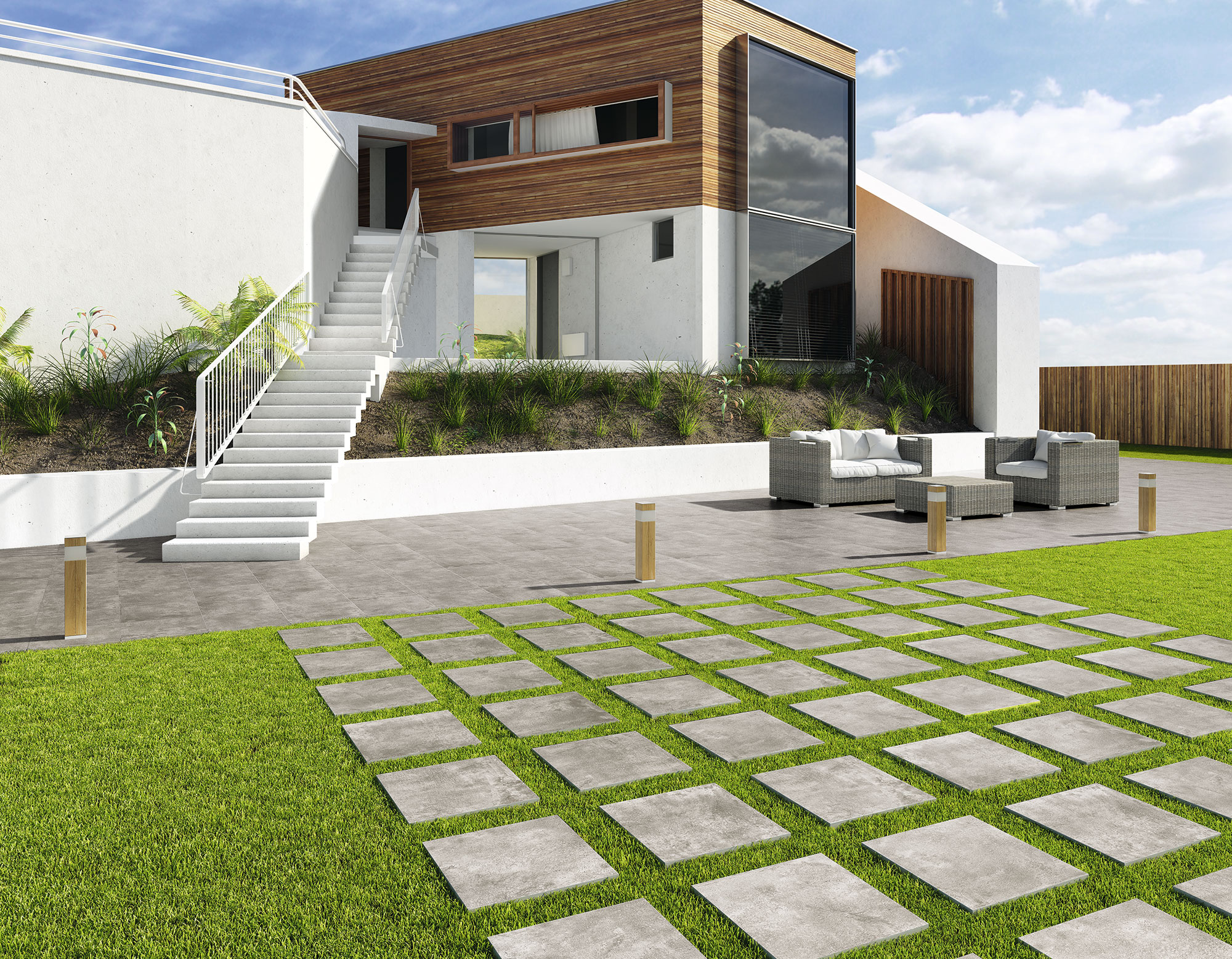 Casa moderna con terraza y camino de losetas cerámicas sobre césped y mobiliario exterior