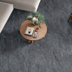 Salón desde arriba con pavimento cerámico gris texturado, mesa circular de madera y sofás