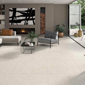 Salón contemporáneo en showroom con amplias baldosas cerámicas beige y terraza ajardinada