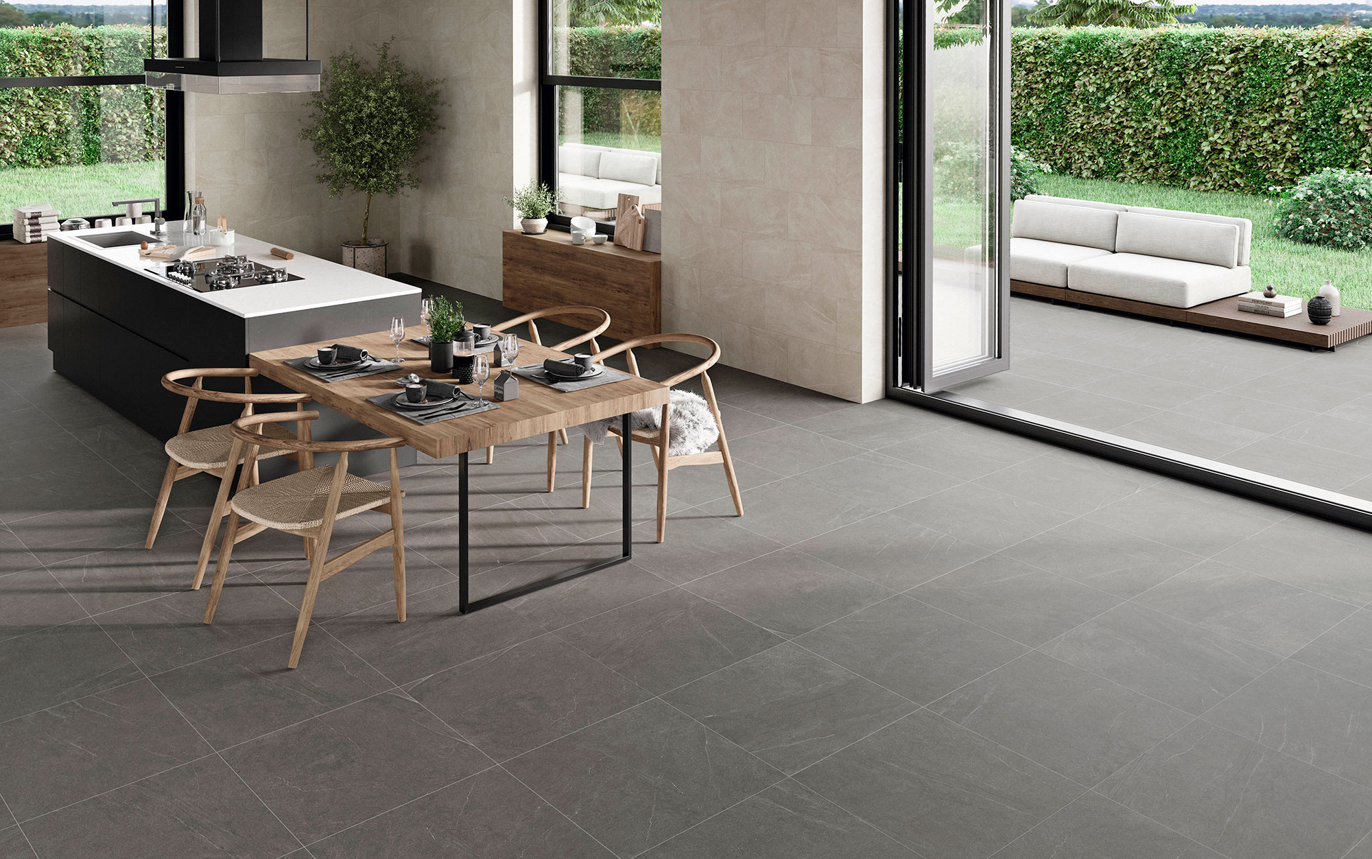 STN-AMB-BELLEVUE-INOUT-STONE-60X60_-IVORY-30X60 Cocina abierta con pavimento cerámico gris, revestimiento mural claro y terraza contigua