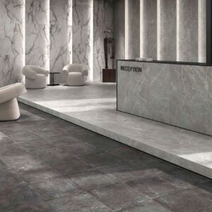 Zona de recepción de tienda con pavimento gris oscuro y paredes revestidas en mármol