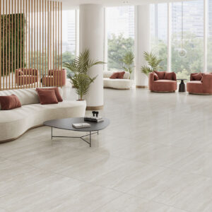 Showroom con pavimento cerámico beige efecto piedra, sofás curvos y butacas terracota