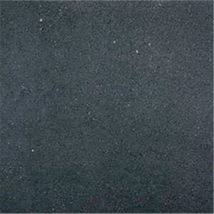 Baldosa cerámica gris antracita mate con microrelieve y ligeras motas blancas