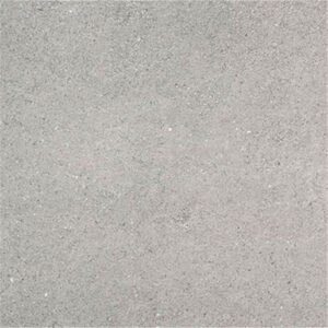 Azulejo cerámico gris claro con textura mate y finas motas