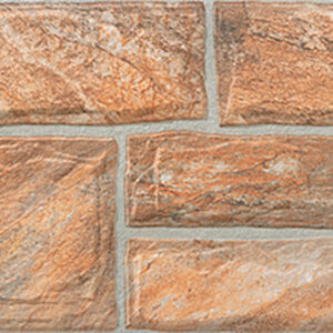 Muestra de revestimiento cerámico efecto piedra en tonos tierra con junta gris