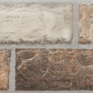 Revestimiento cerámico tipo ladrillo rústico en tonos beige y marrón con junta gris