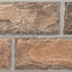 Revestimiento cerámico tipo ladrillo envejecido en tonos tierra con juntas grises