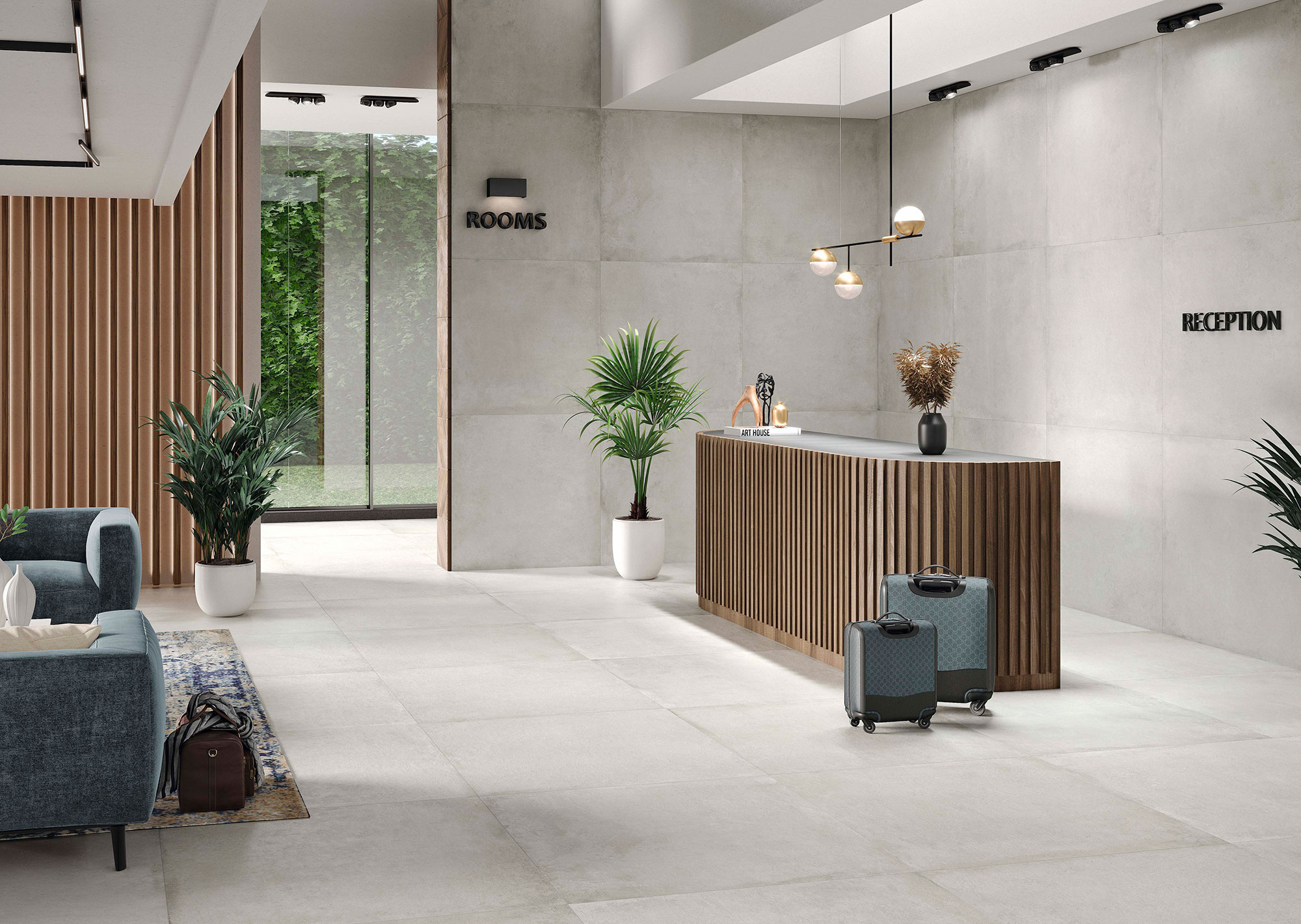 Recepción en tienda con suelos, paredes gran formato cerámico, mostrador listonado y plantas.