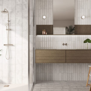 Baño moderno: ducha y mueble lavabo flotante sobre azulejos cerámicos claros.