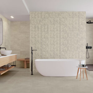 Baño expositor con bañera independiente, pared de azulejos geométricos y mueble flotante de madera.