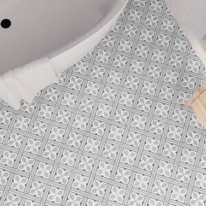 Baño con pavimento cerámico blanco y gris de motivos geométricos, bañera y mueble