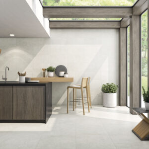 Showroom de cocina con pavimento y revestimiento cerámico claro, isla junto a ventanales