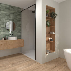 Baño moderno con azulejos verdes, lavabo sobre mueble flotante de madera y bañera exenta