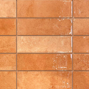 Azulejos cerámicos rectangulares brillo terracota en disposición tipo metro