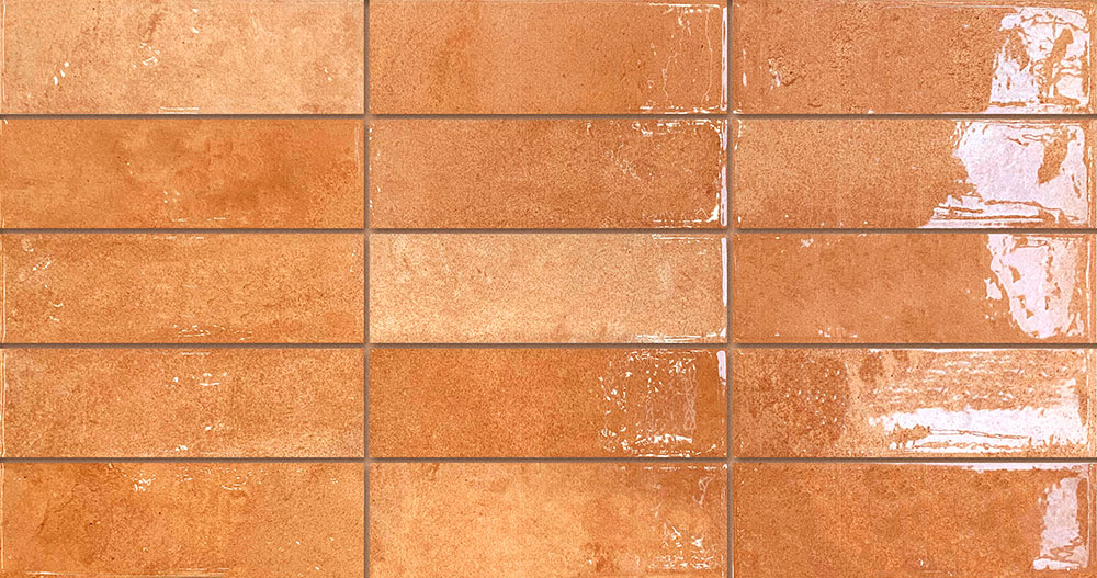 Azulejos cerámicos rectangulares brillo terracota en disposición tipo metro
