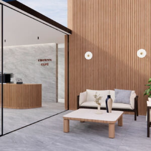 Showroom de cerámica con suelos y revestimientos gris mármol, listonado de madera y zona lounge