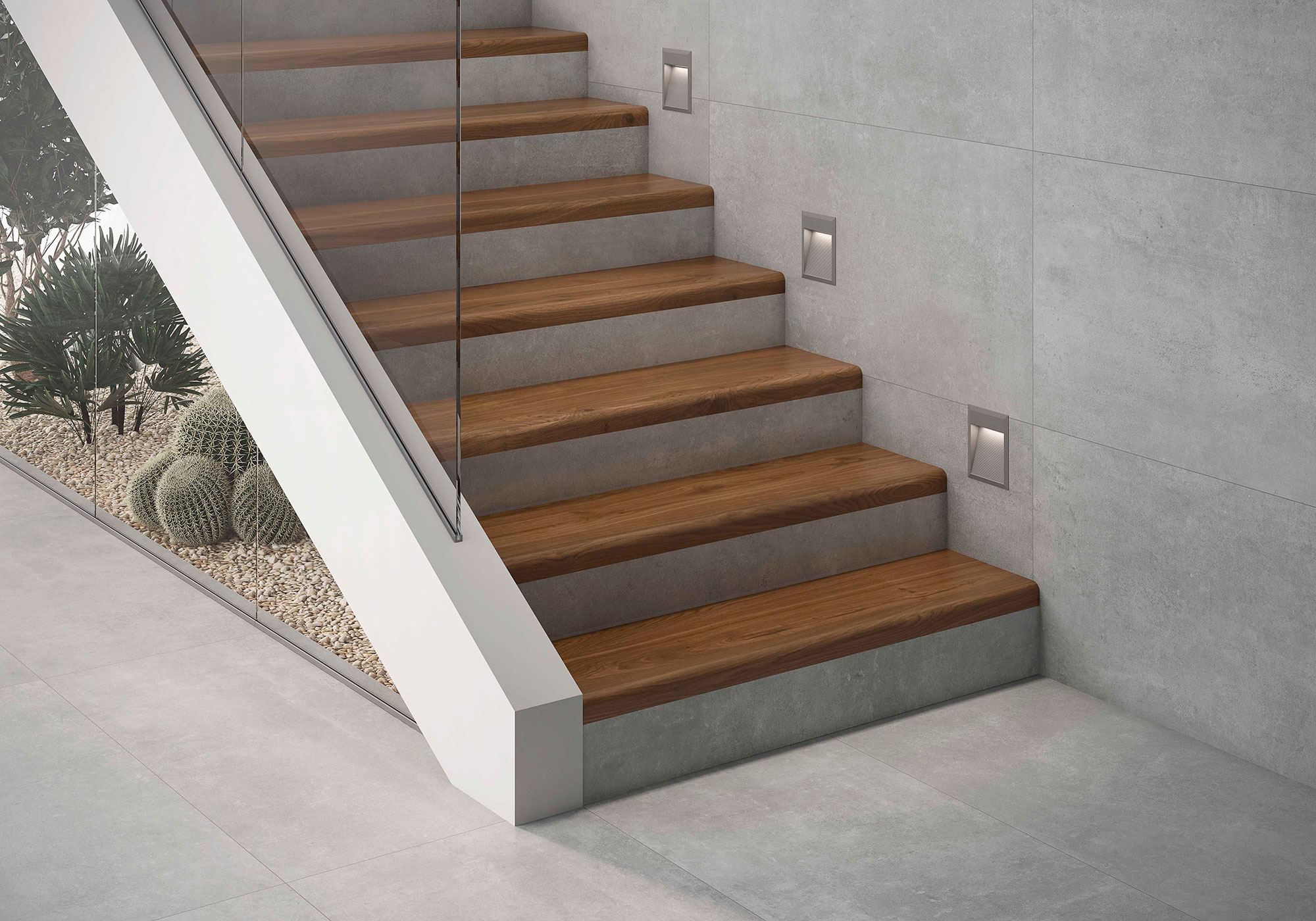 amb-01-MIRO-32x120 Escalera con peldaños de madera y revestimientos cerámicos efecto hormigón, barandilla de vidrio