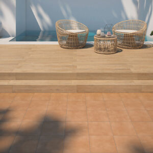Terraza con piscina, escalón cerámico efecto madera y pavimento exterior en tono terracota